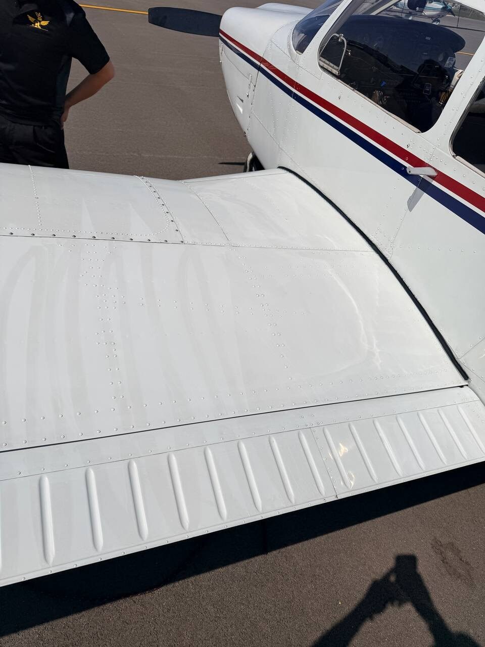 Before: hard buffing lines and surface haze on the Piper Arrow wing