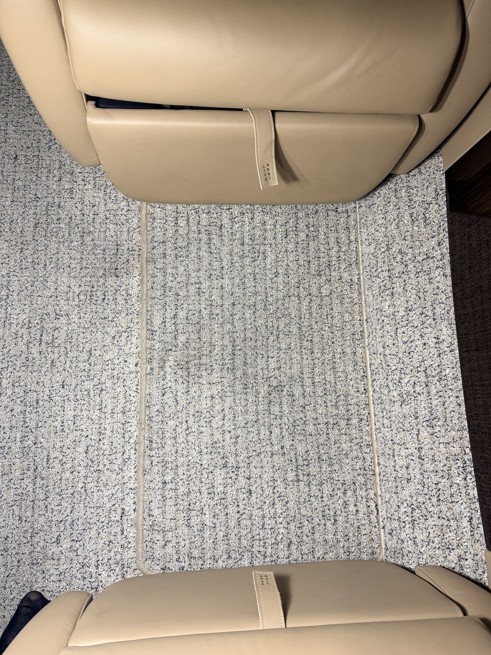 Before: under-seat carpet staining and lower cabin buildup on the Challenger 300