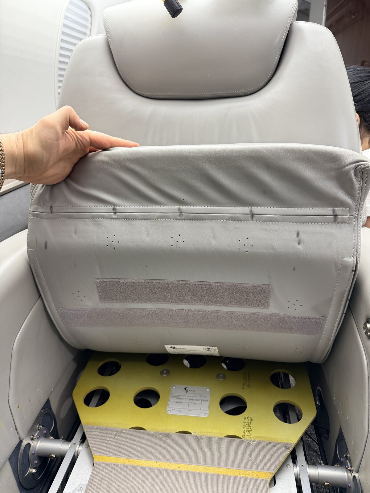 Before: low-visibility staining below a Challenger 350 cabin chair with seat pan exposed