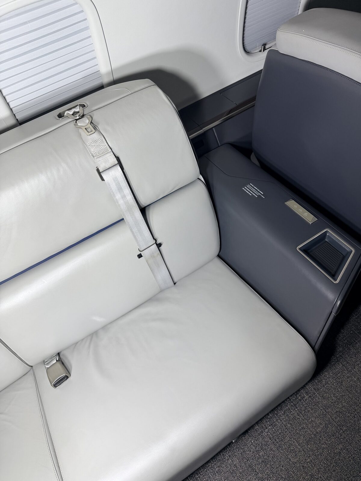 After: Challenger 350 cabin couch and sidewall presentation with clean leather and dark accent panel
