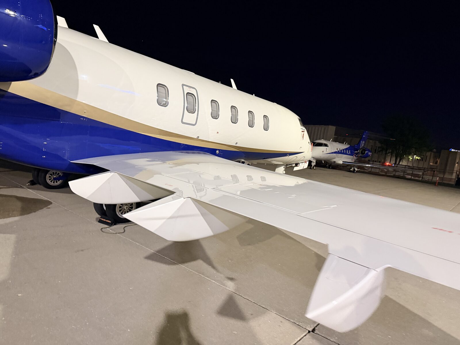 Bombardier Challenger 350 wing and fuselage on the ramp at Chicago Executive Airport PWK at night
