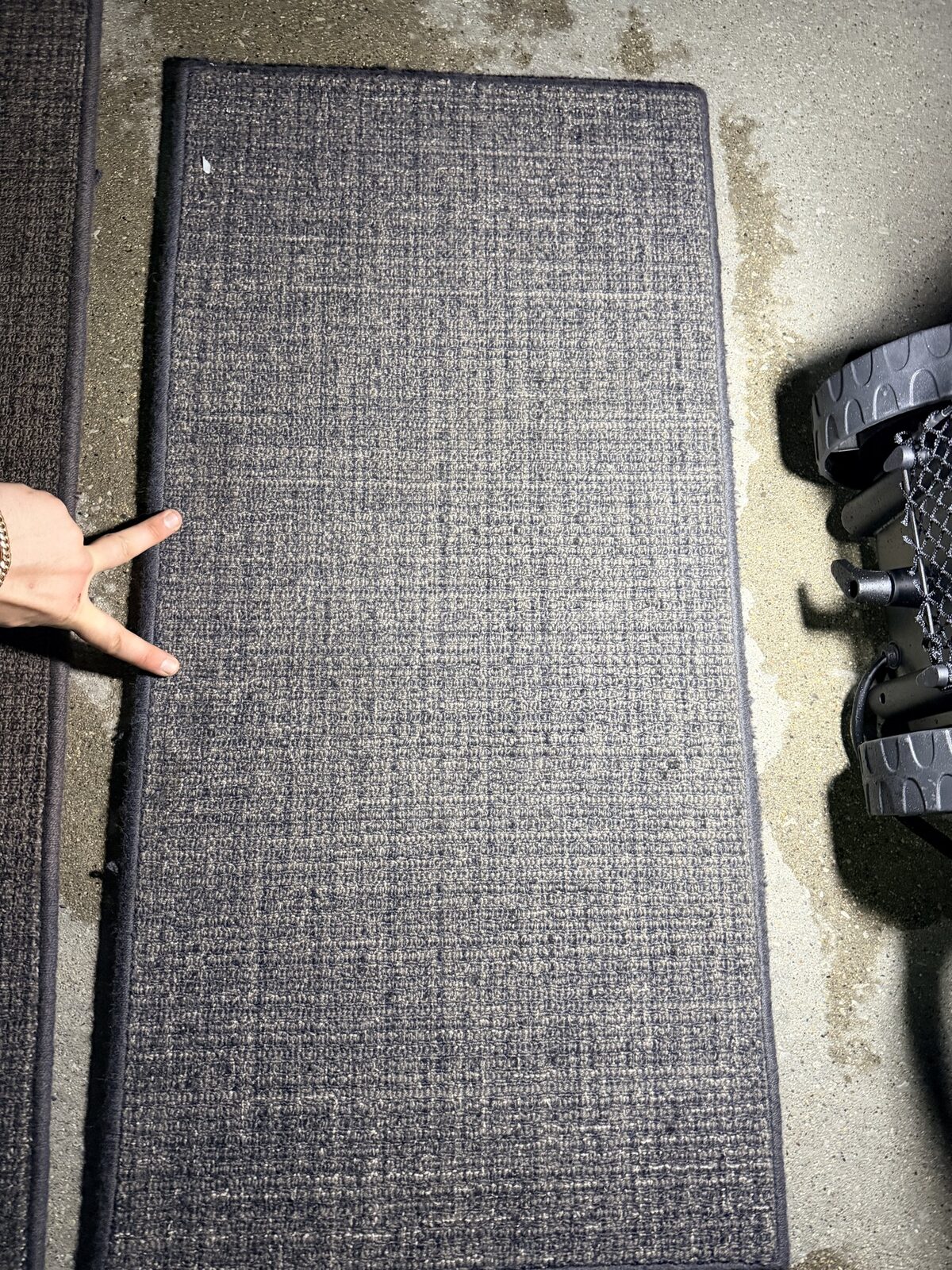 Before: removable cabin carpet with visible spot staining on Challenger 350