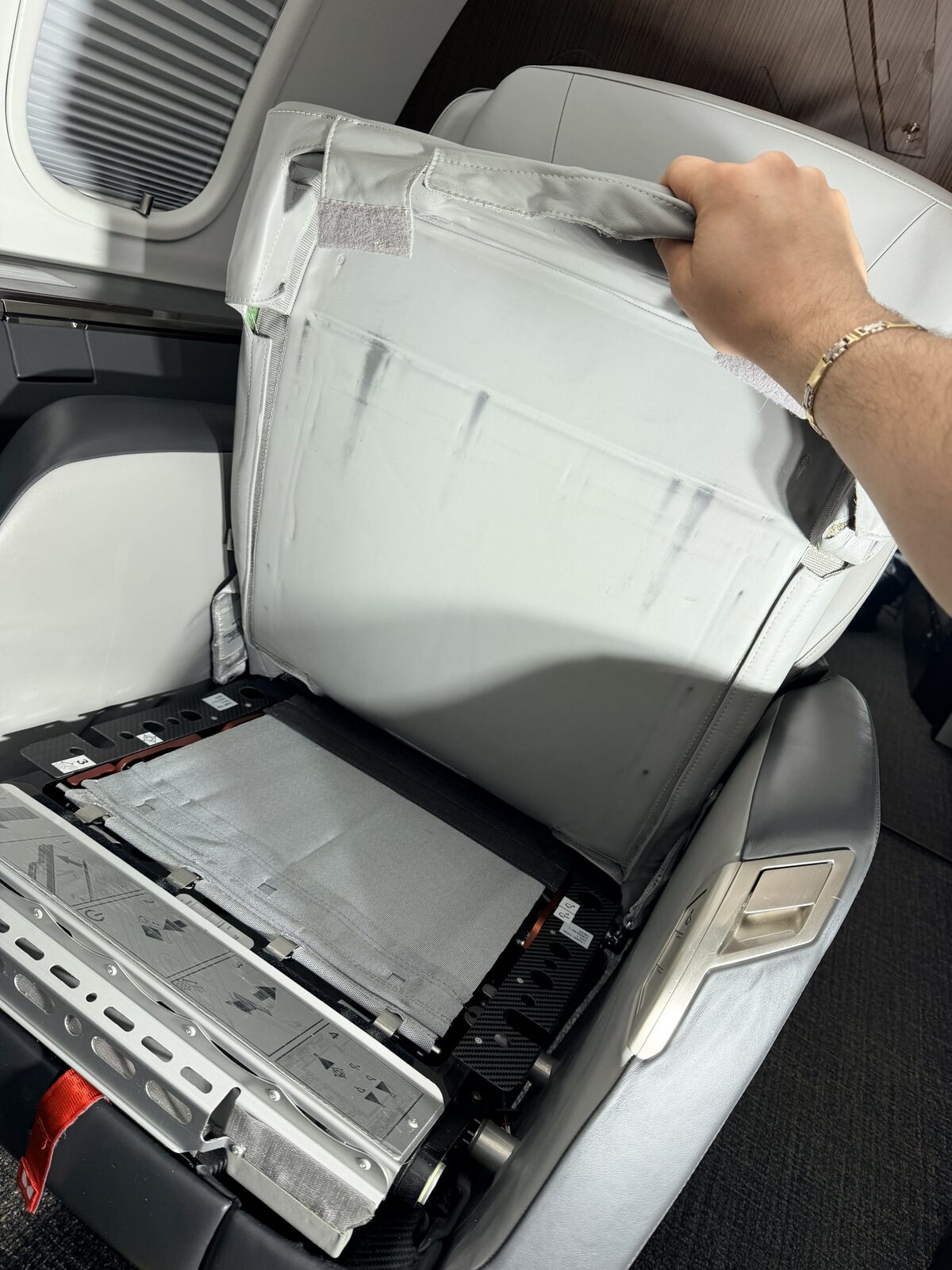 Before: black marks on lower under-seat leather panel exposed with seat cushion lifted