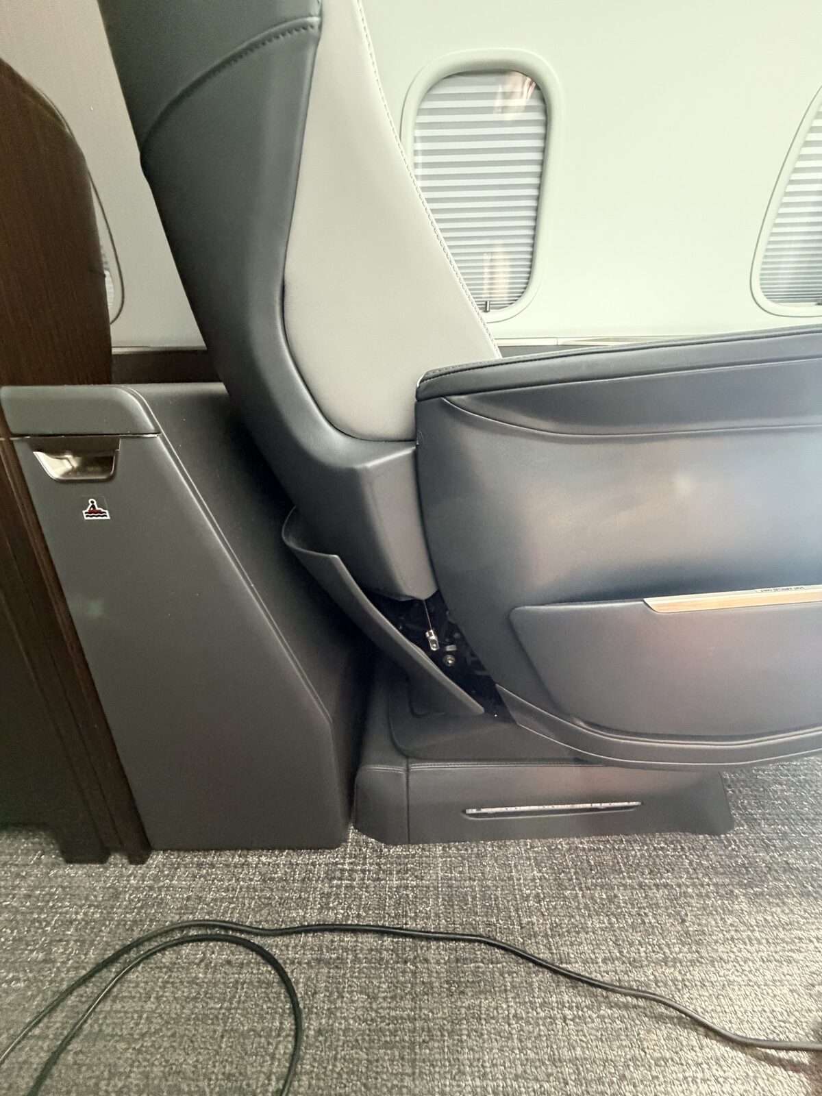 Before: forward passenger-seat panel documented out of place on Challenger 350 cabin chair