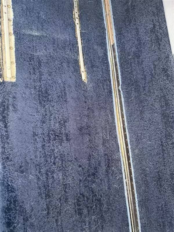 Before: carpet buildup around seat-track-adjacent areas