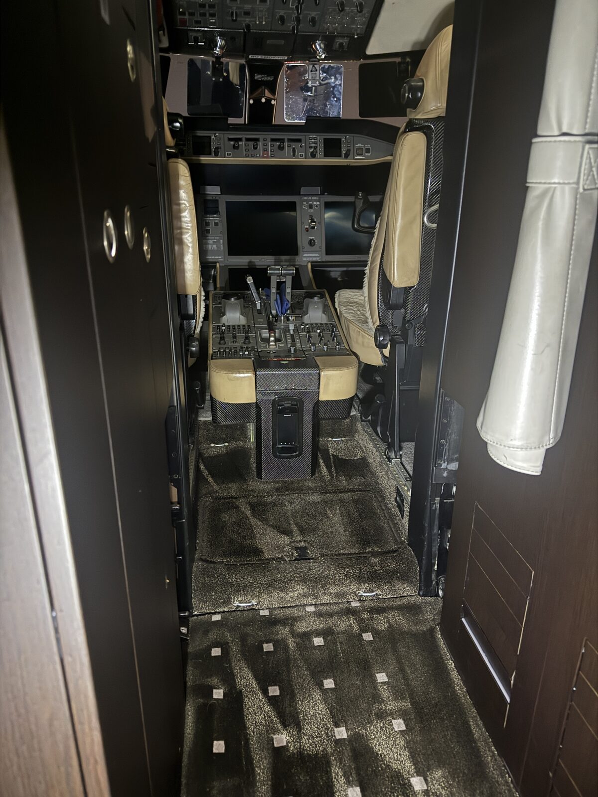 After: front lavatory and cockpit-entry carpet reset following extraction on Global 5000