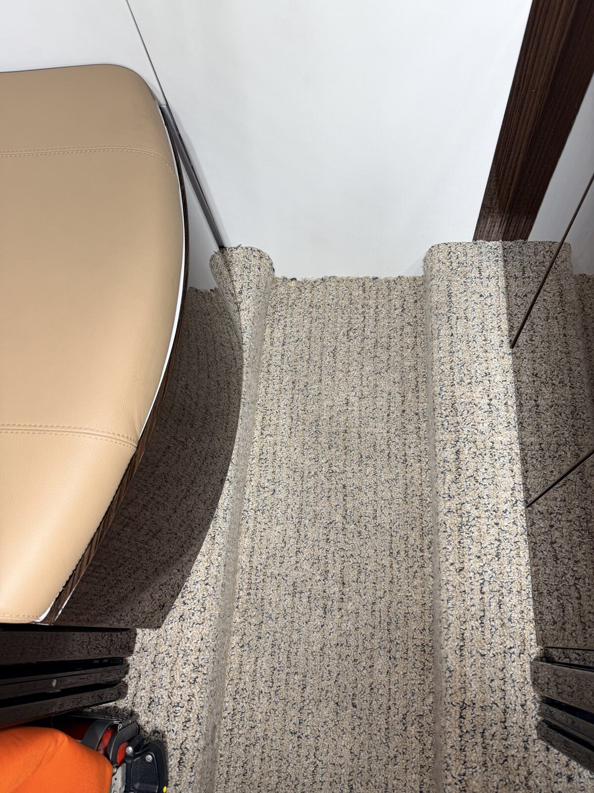 Before: aisle carpet spotting and fiber contamination in Phenom 300