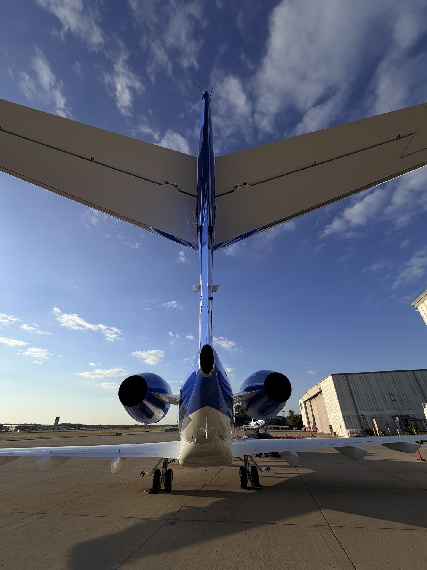 Bombardier Challenger 300 T-tail empennage and twin Honeywell engines rear view after exterior detailing at PWK