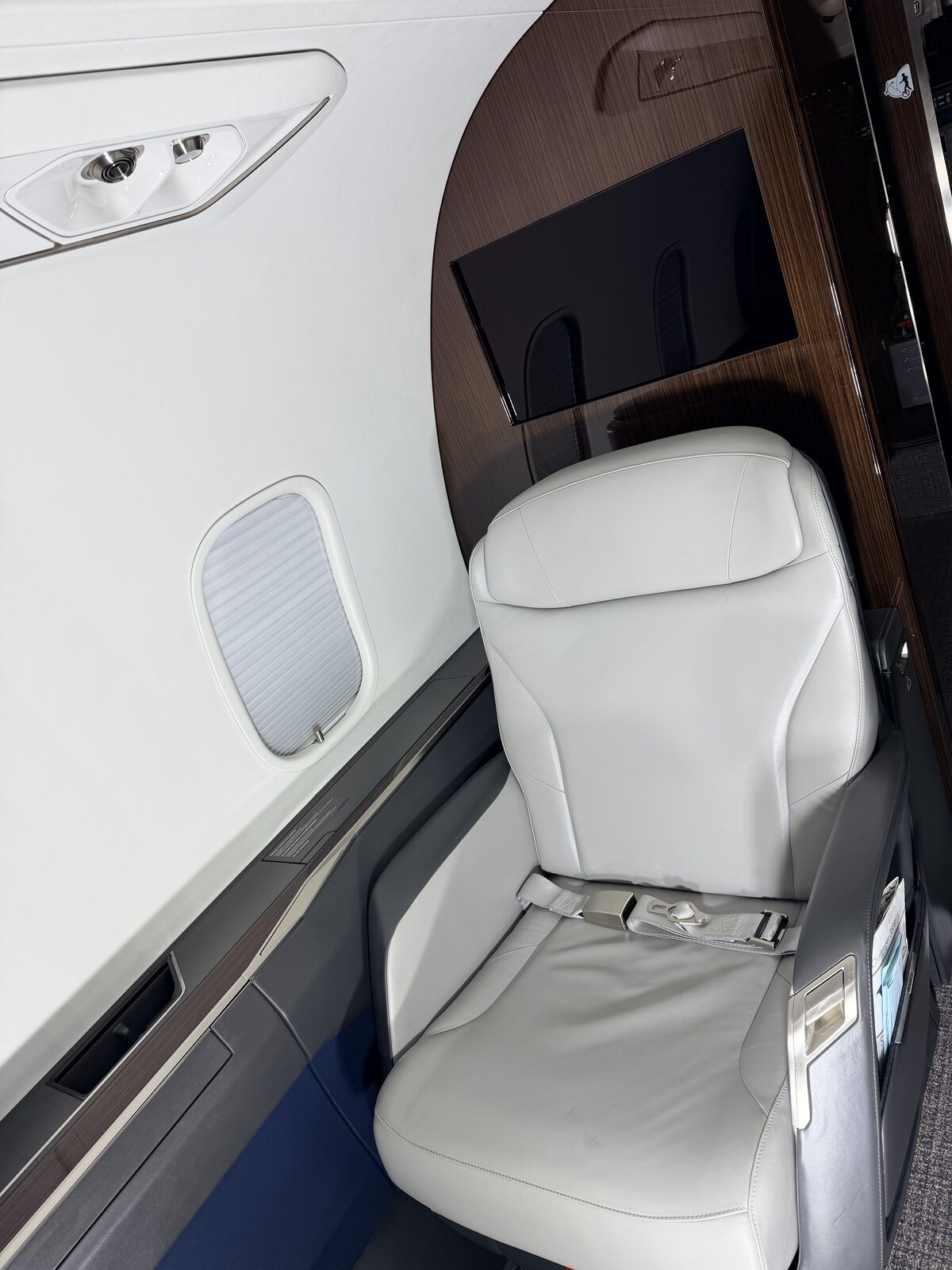 Bombardier Challenger 350 interior club seat monitor cutout wood table overhead panel window detailing