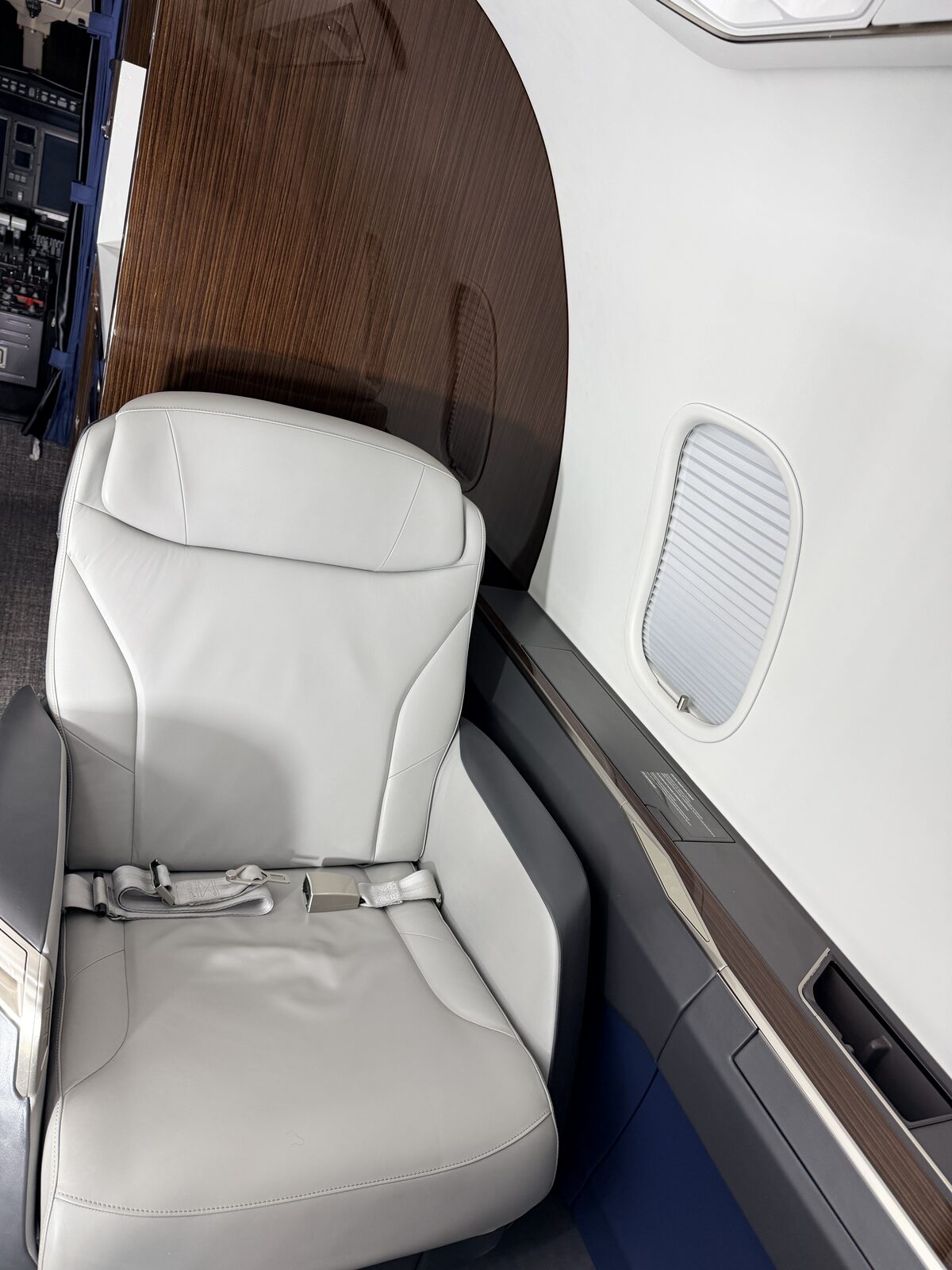 Bombardier Challenger 350 interior club seat window shade wood table blue accent sidewall detailing
