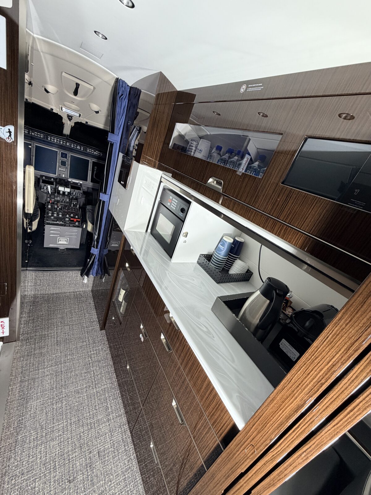 Bombardier Challenger 350 interior forward galley credenza monitor coffee water cockpit view detailing