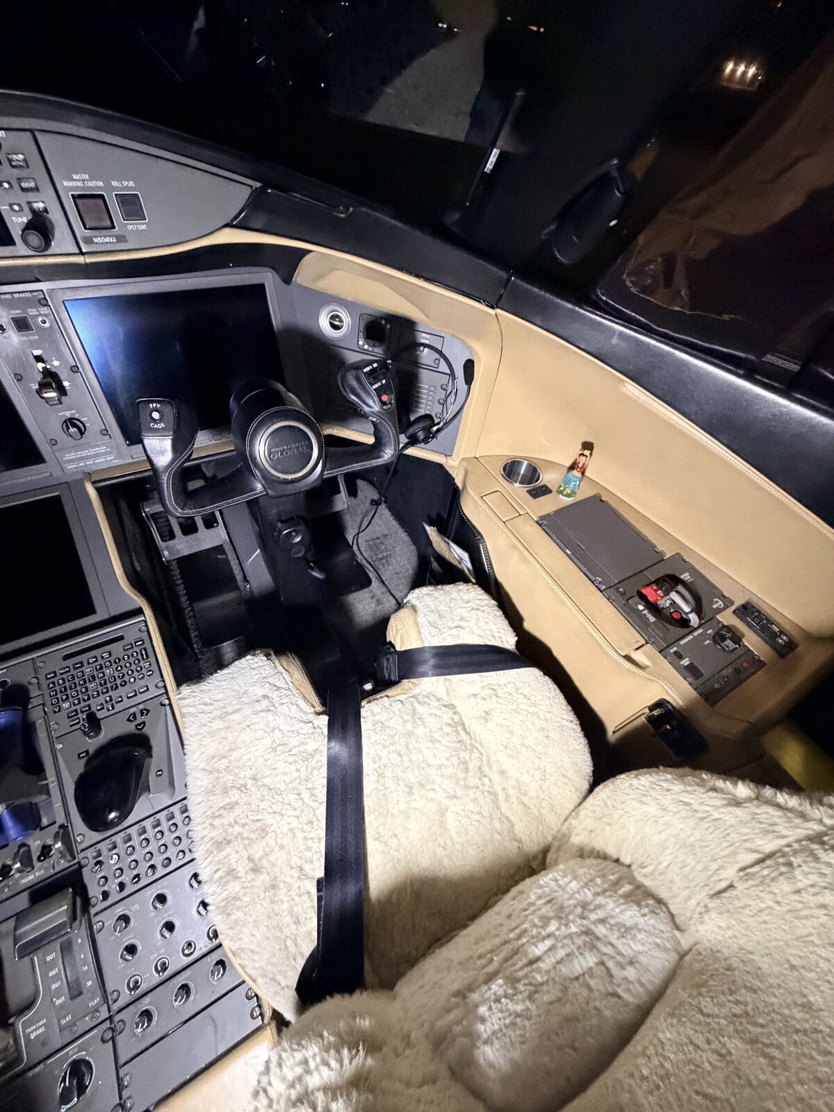 Cessna Citation Excel first officer side cockpit with sidestick, center console, and sheepskin seat cover after detailing