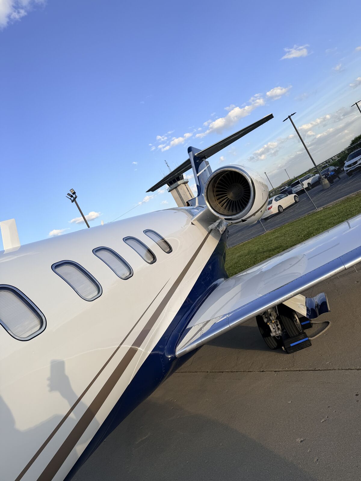Cessna Citation Excel fuselage side profile showing passenger windows and rear engine on airport ramp after detailing