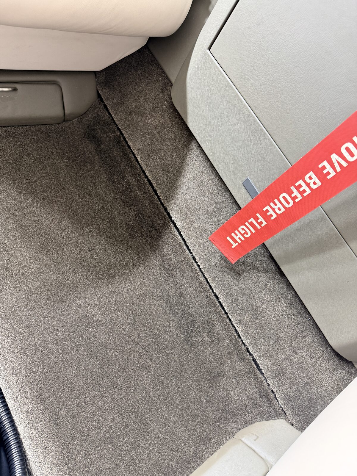 Cessna Citation X interior cabin floor carpet closeup dark grey remove before flight aviation detailing