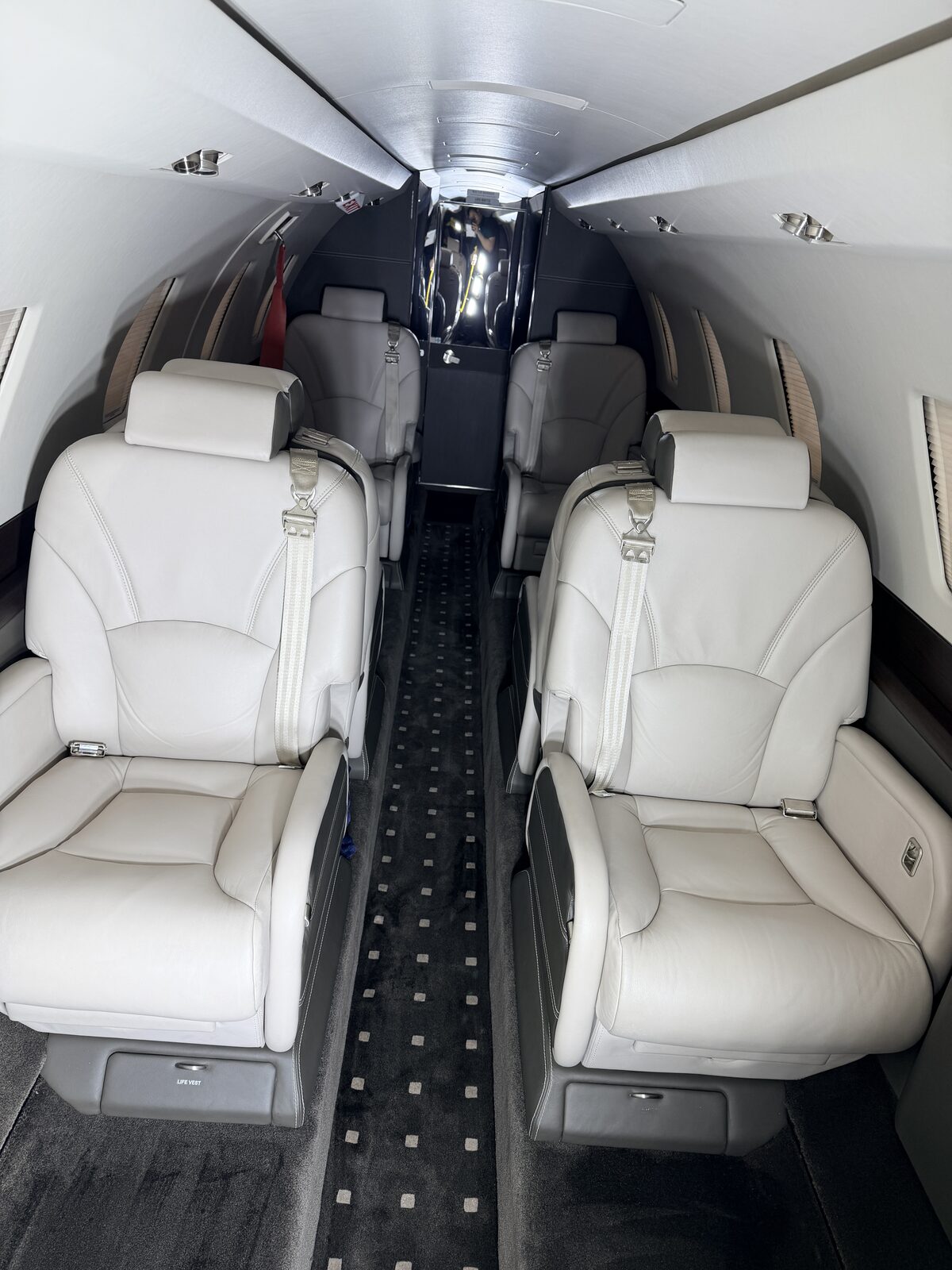 Cessna Citation X interior club seat carpet runner dark sidewall window shade white leather detailing