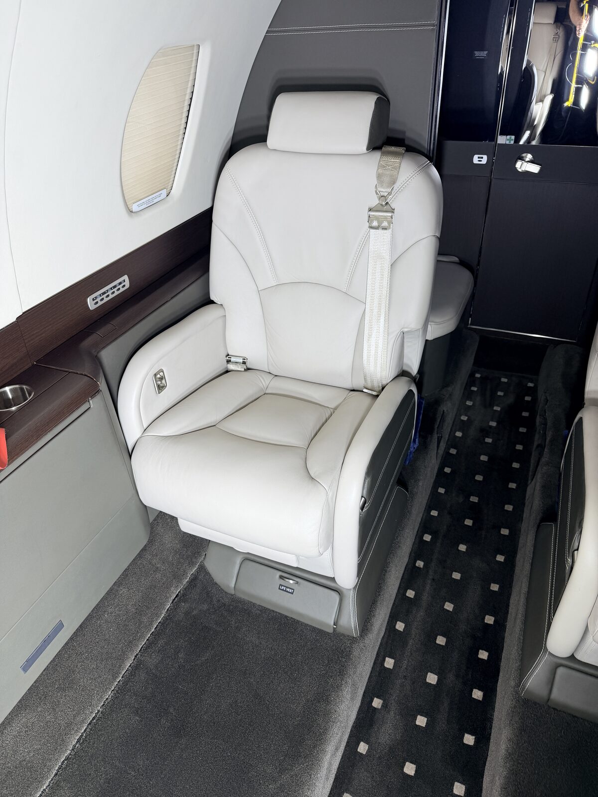 Cessna Citation X interior club seat window shade white leather dark sidewall wood veneer detailing