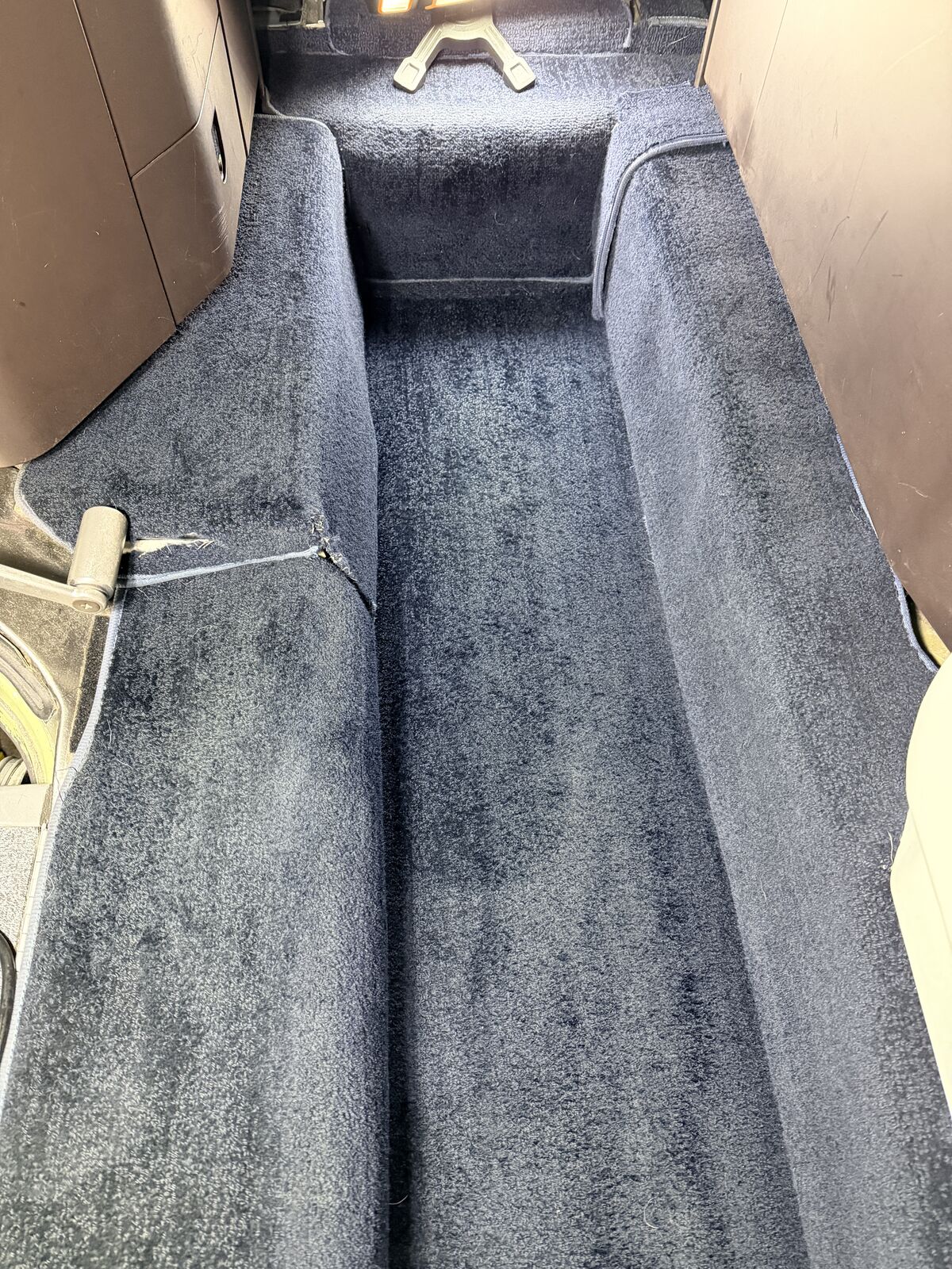Private jet cabin navy blue aisle carpet looking forward through seats after carpet extraction and interior detailing