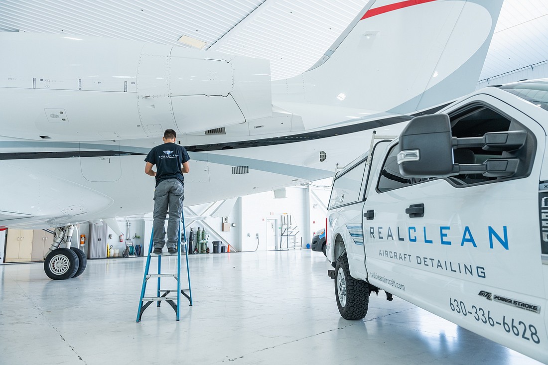 Mobile aviation detailing service vehicle on airport ramp near private jet in Chicago area