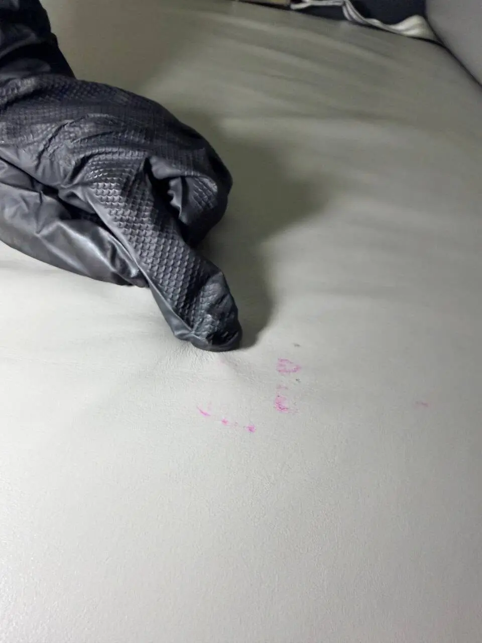 Before: lipstick stain on Challenger 350 back couch leather — prior removal attempts by other teams were unsuccessful