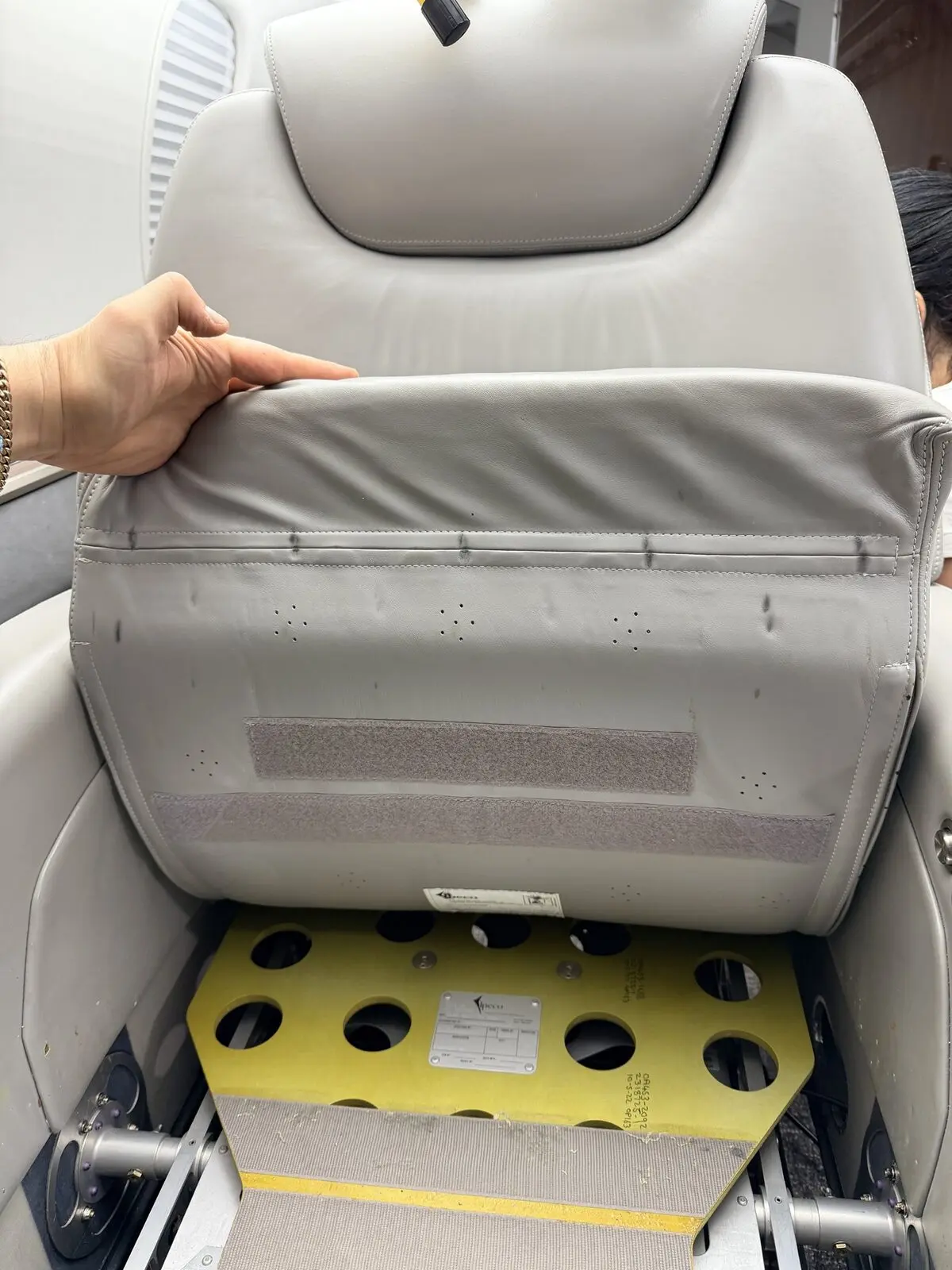 Before: low-visibility staining below a Challenger 350 cabin chair with seat pan exposed