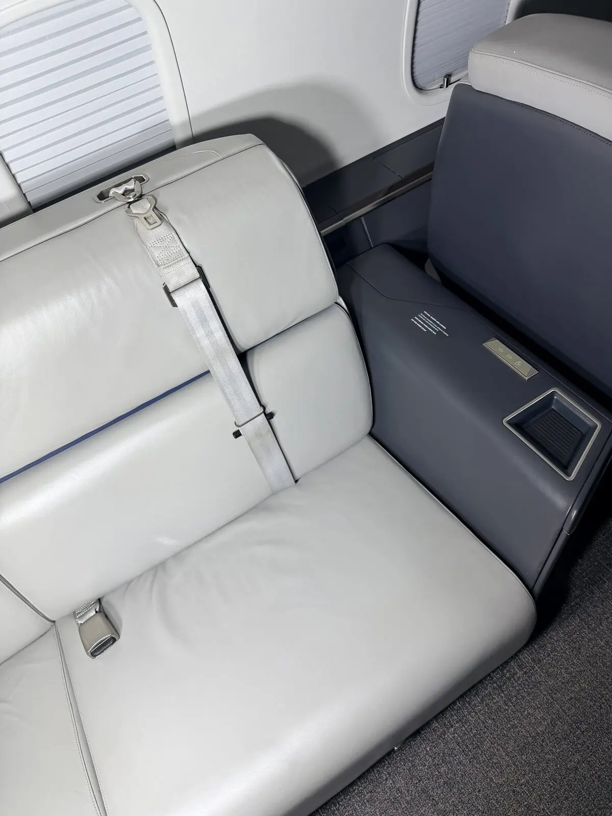 After: Challenger 350 cabin couch and sidewall presentation with clean leather and dark accent panel