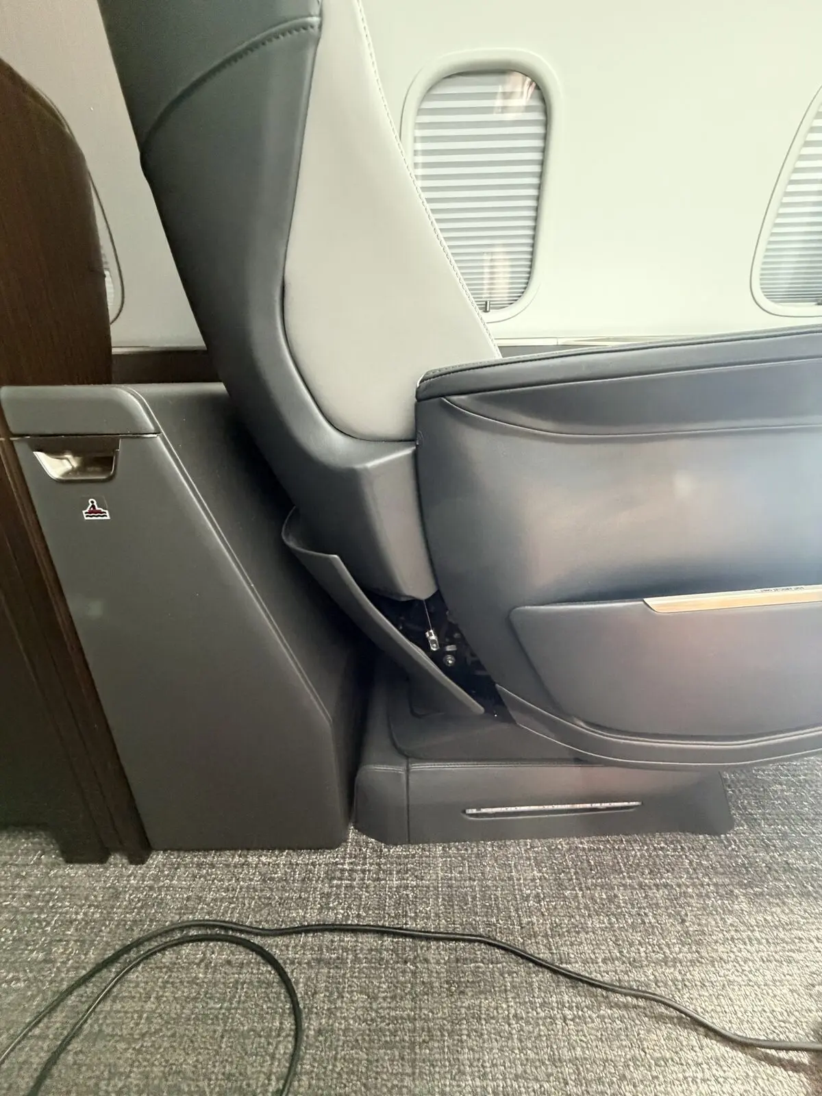 Before: forward passenger-seat panel documented out of place on Challenger 350 cabin chair