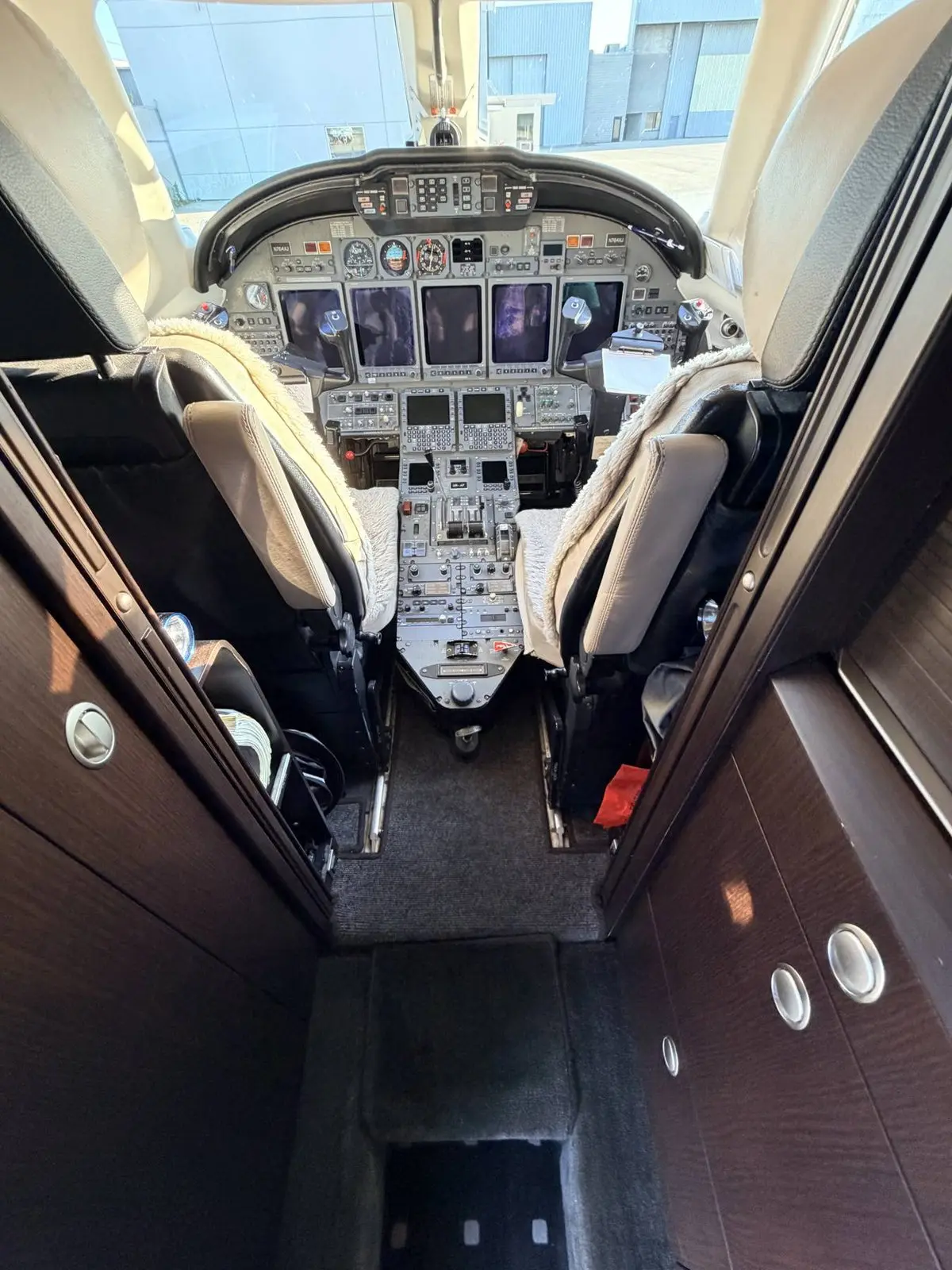 Cessna Citation X cockpit-entry aisle and forward cabin reset with clean carpet runner and polished veneer