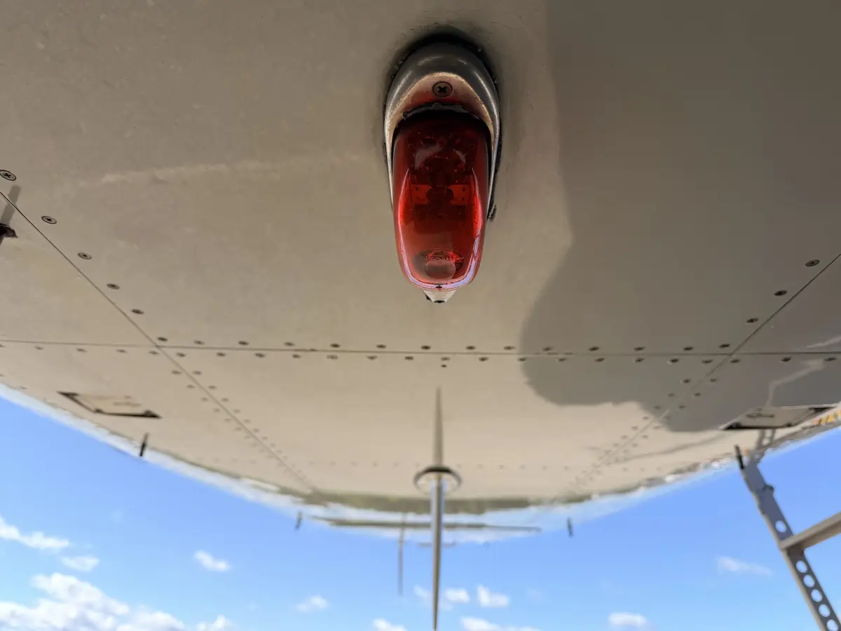 Underside view of a Cessna Citation X looking up at the anti-collision beacon, antennas, and rivet lines after cleaning