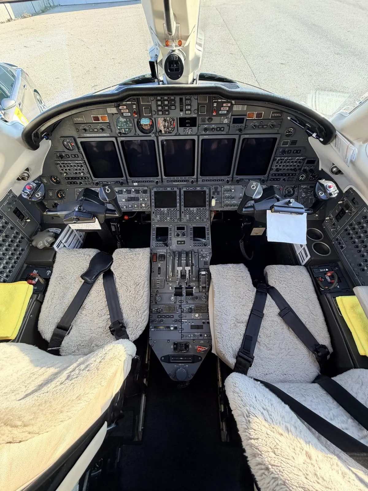 Cessna Citation X glass flight deck with multi-display avionics, center pedestal, and protected crew seats after a presentation-only cockpit reset
