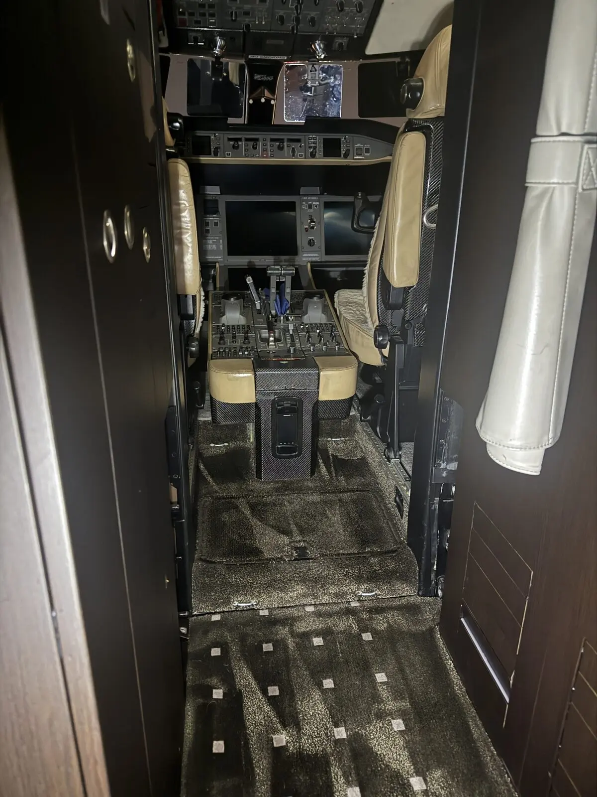 After: front lavatory and cockpit-entry carpet reset following extraction on Global 5000