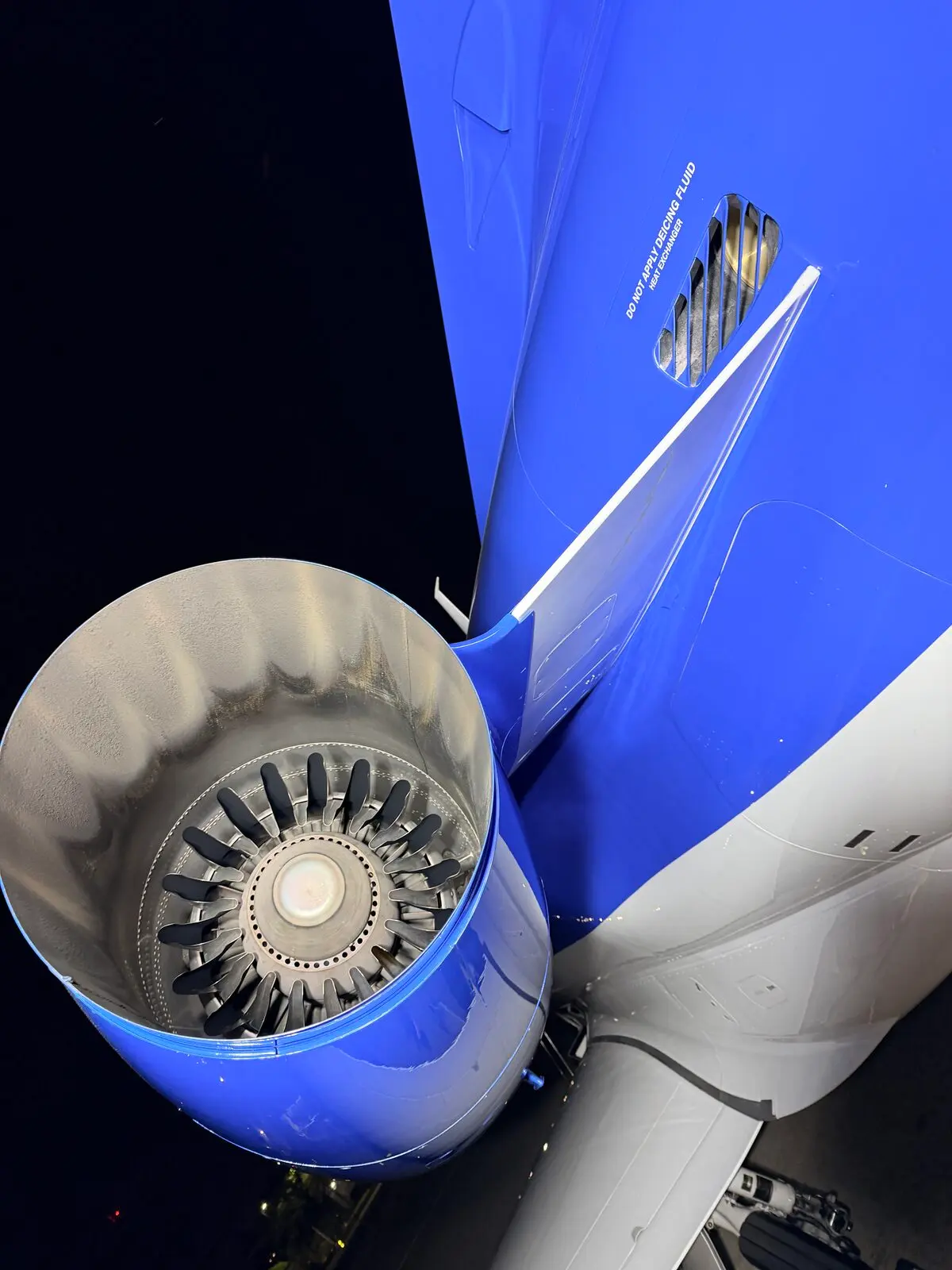 Phenom 300 engine nacelle closeup showing fan blades and blue cowling after detail