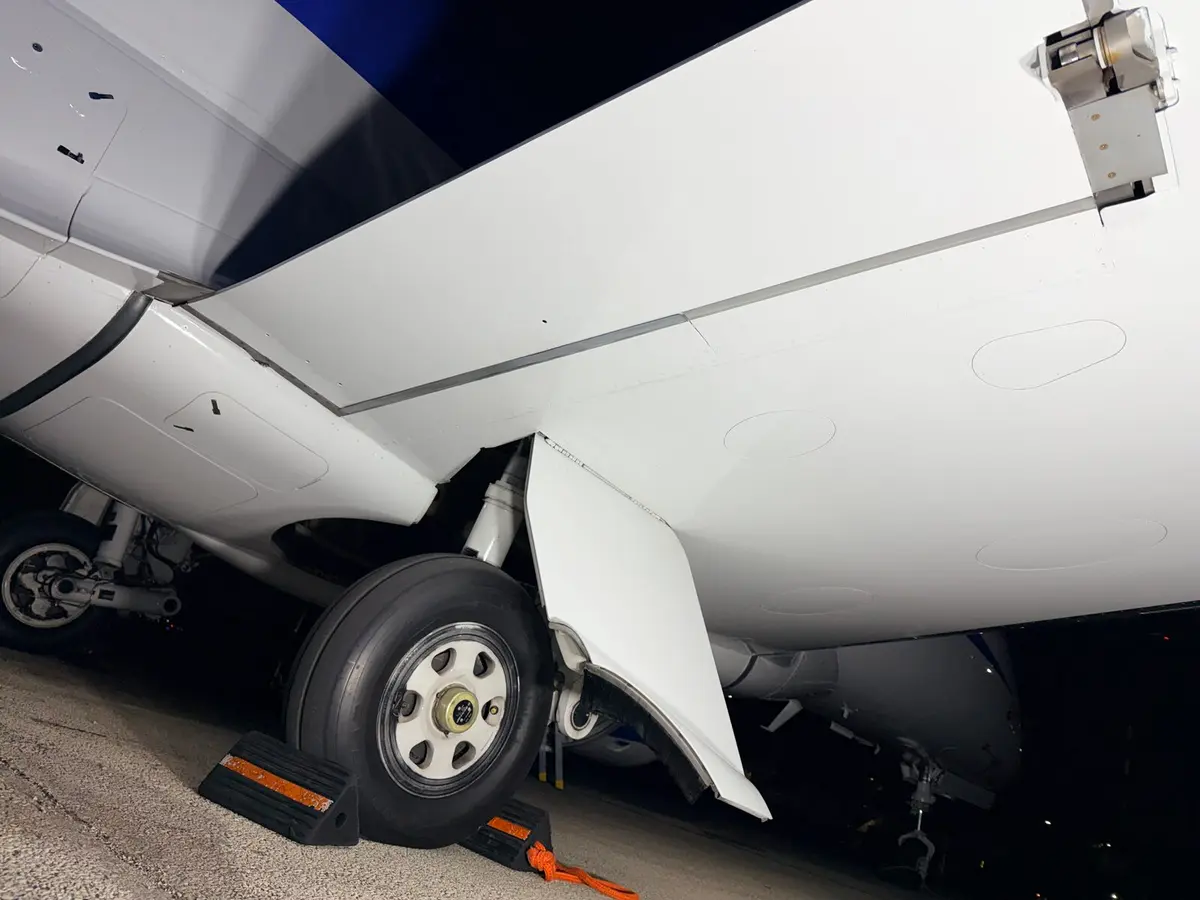 Phenom 300 main landing gear and lower fuselage with wheel chocks after exterior cleaning