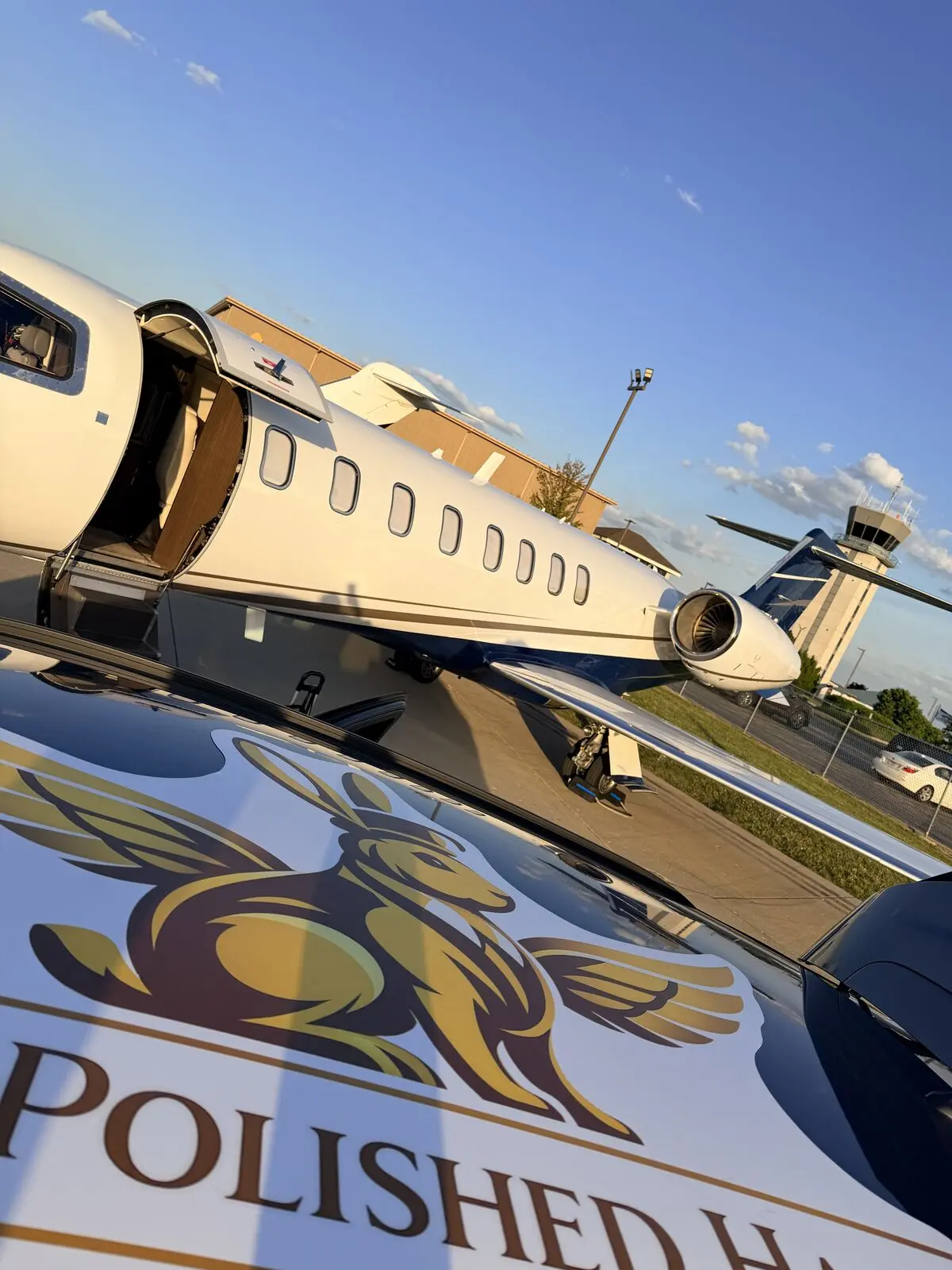The Polished Hare branded service vehicle parked on ramp next to Cessna Citation Excel showing company logo and aircraft